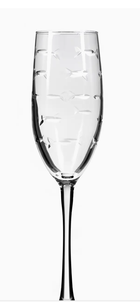 Clear champagne flute with engraved school of fish